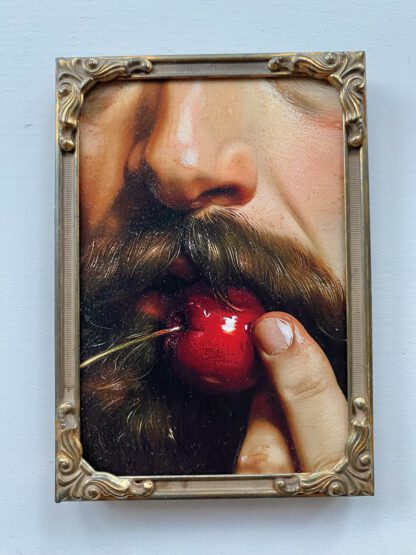 A man bites a cherry