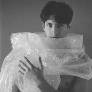 Analog photograph of a bare male torso partially covered with bubble wrap, exploring masculinity, protection, fragility and artificiality.